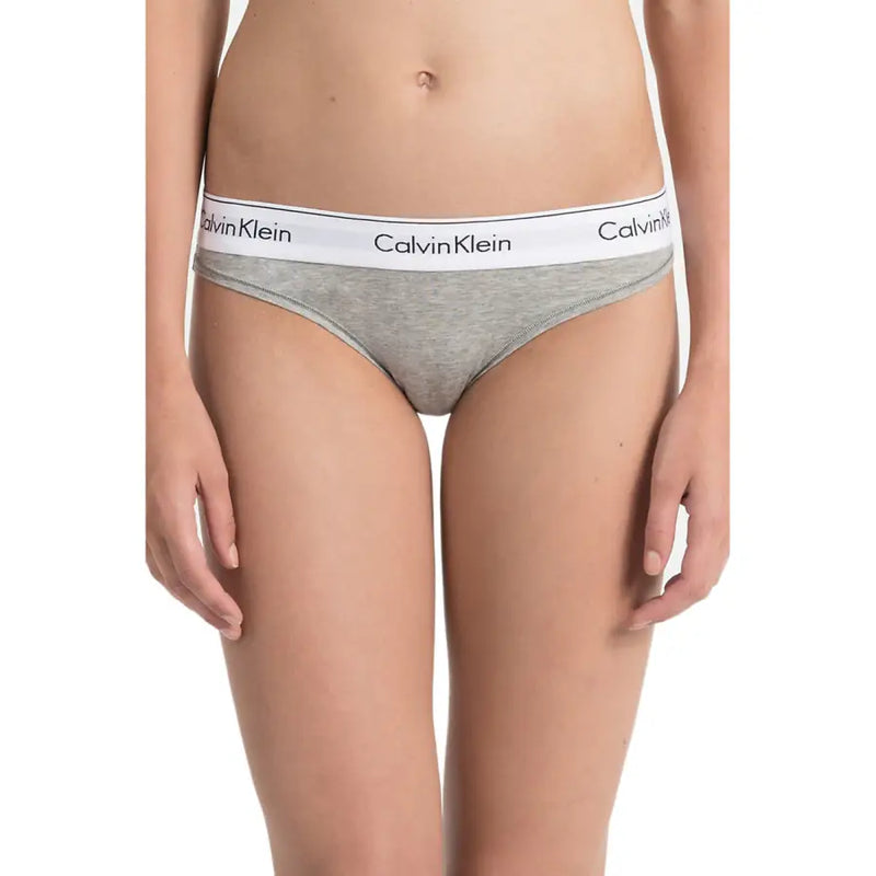 Calvin klein girls grey briefs with a white logo waistband made from cotton and modal blend fabric