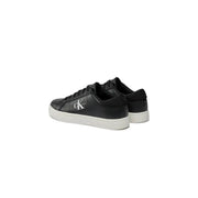 Black leather calvin klein sneakers with white soles and monogram logo.