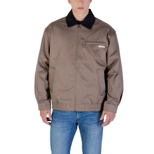 Brown bomber jacket with black collar and pockets, likely made of nylon or polyester.