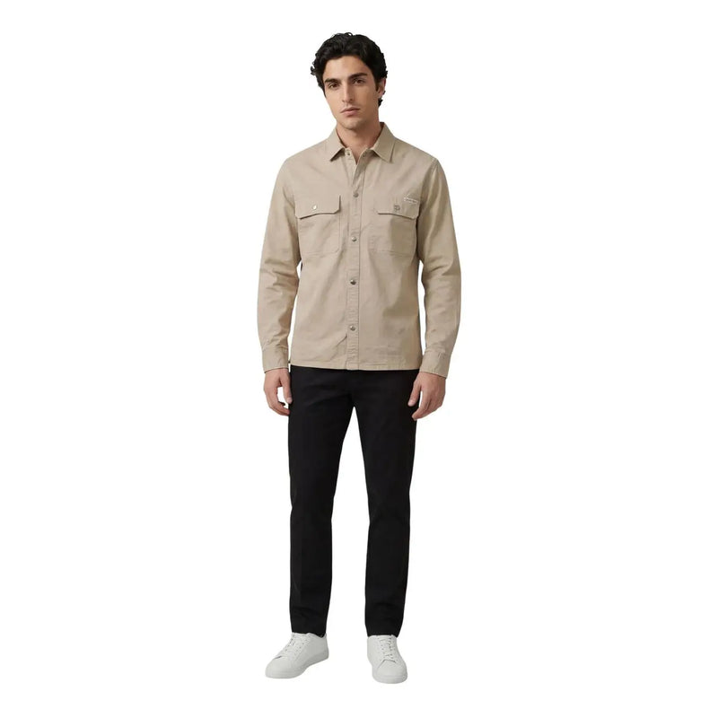 Beige Calvin Klein Jeans men long-sleeved button-up shirt with two chest pockets and subtle logo on left pocket