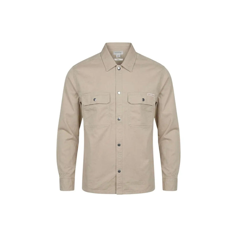 Beige long-sleeved button-up Calvin Klein Jeans men shirt with two chest pockets and subtle brand patch on left pocket