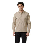 Beige long-sleeved button-up Calvin Klein Jeans shirt with two chest pockets and subtle brand patch on left pocket