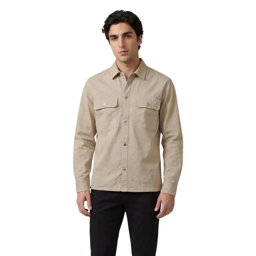 Beige long-sleeved button-up Calvin Klein Jeans shirt with two chest pockets and subtle brand patch on left pocket