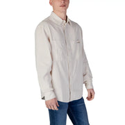 A cream-colored beige cotton long-sleeved button-up shirt with chest pocket and Calvin Klein logo for spring summer