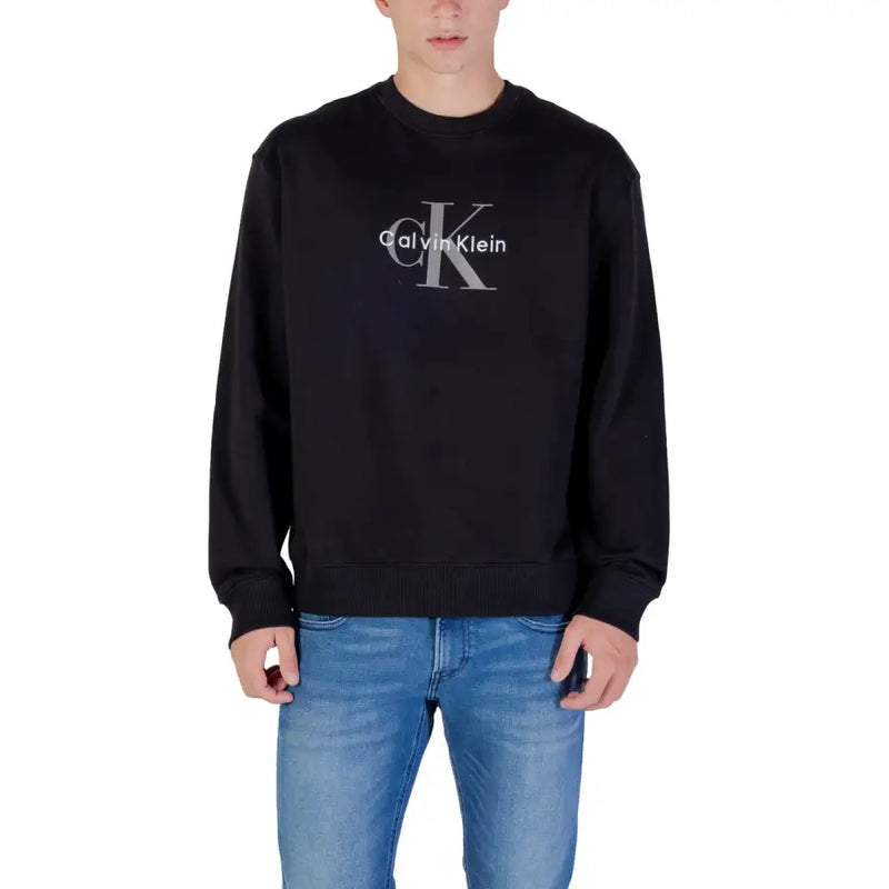 Men’s black Calvin Klein sweatshirt paired with blue jeans, showcasing casual style