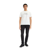 White calvin klein t-shirt with black logo and horizontal lines paired with black cotton denim slim jeans for men