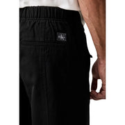 Calvin Klein Jeans Schwarze Herren-Baumwollhose mit Kordelzug, elegantem, minimalistischem Design und dezentem Logo-Patch am Bund
