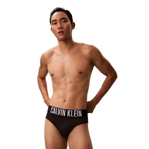Calvin Klein Jeans men black swimwear polypropylene briefs with a white logo waistband