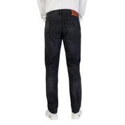 Dark-wash slim fit Calvin Klein cotton jeans for men with black zip button and brown leather brand patch at waistband
