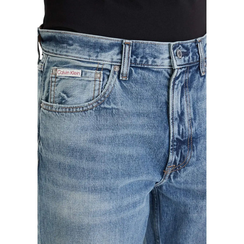 Back view of medium-wash blue calvin klein jeans for men with classic five-pocket design 100 percent cotton material