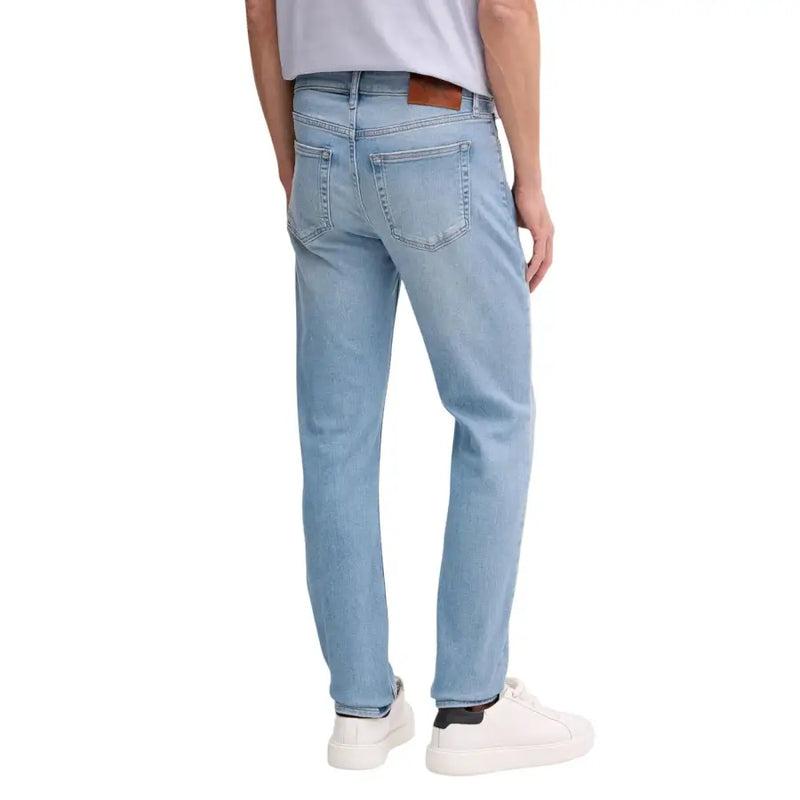 Calvin Klein Herrenjeans aus hellblauem Baumwoll-Denim mit klassischem geradem Bein und braunem Lederpatch