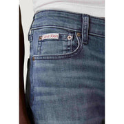 Back side of blue cotton denim slim fit jeans for men with calvin klein brand label on the back pocket