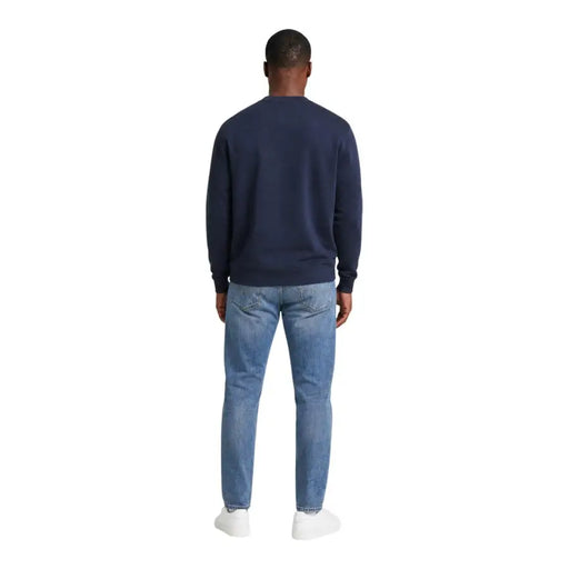 Calvin klein jeans men blue cotton crewneck sweatshirt paired with light-wash denim jeans for casual wear