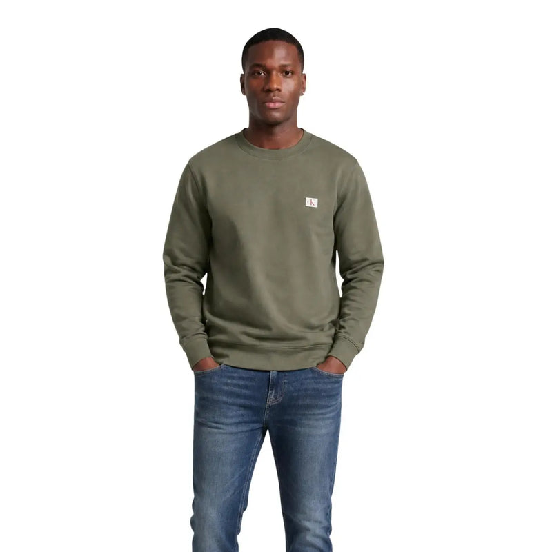 Calvin Klein Jeans Grünes Herren-Sweatshirt aus Baumwolle mit Rundhalsausschnitt und kleinem weißen Logo-Aufnäher auf der linken Brust