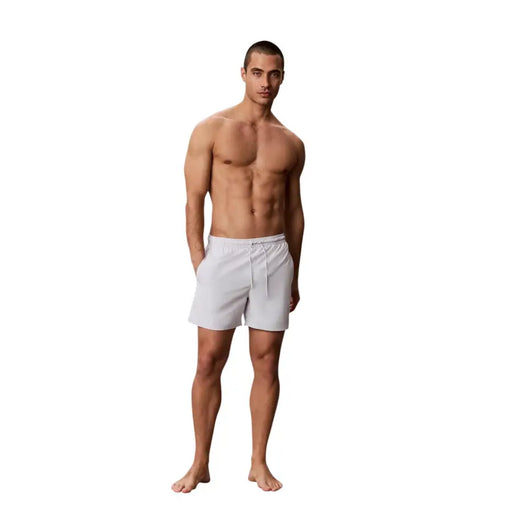 Calvin Klein Jeans men grey medium drawstring swimwear shown as white athletic shorts with drawstring waistband