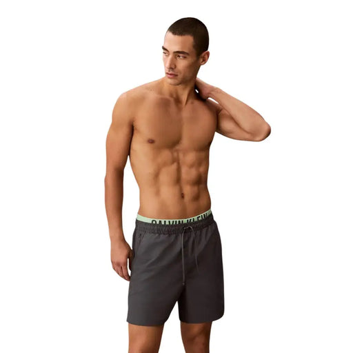 Calvin Klein Jeans men grey polyester swim shorts with dark gray fabric and light green logo waistband medium size