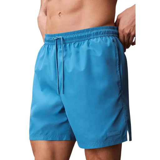 Calvin Klein Jeans men light blue polyester swim shorts with elastic waistband and matching drawstring
