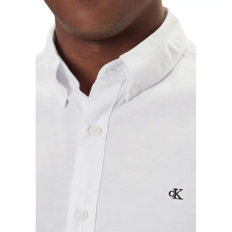 Calvin Klein Jeans Weißes Herrenhemd mit dezenter Webstruktur und schwarzem, gesticktem Logo auf der linken Brustseite.