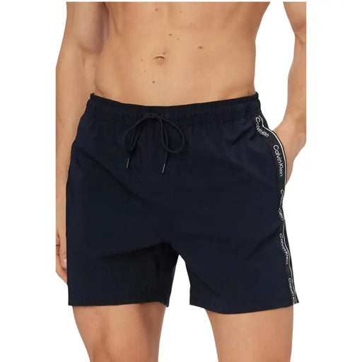 Dark navy Calvin Klein Jeans men swimwear swim trunks with white logo stripe along the side for swimming use