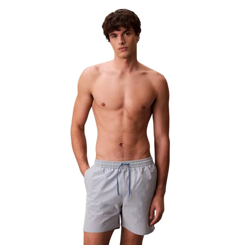 Calvin Klein Jeans men swimwear striped swim trunks in light blue and white with matching drawstring closure