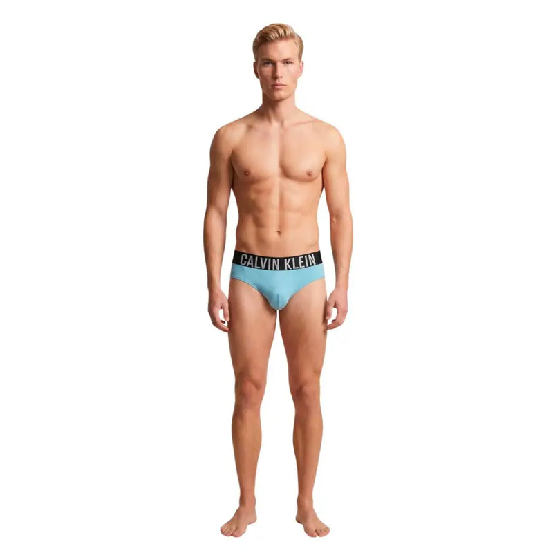 Light blue Calvin Klein Jeans men swimwear briefs with black waistband and white logo lettering