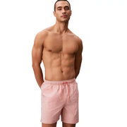 Calvin Klein Jeans men swimwear pink and white striped swim trunks with drawstring waistband for casual beachwear