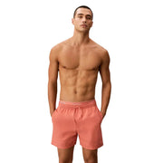 Coral-colored Calvin Klein Jeans men swimwear swim trunks with elastic waistband and drawstring for beachwear