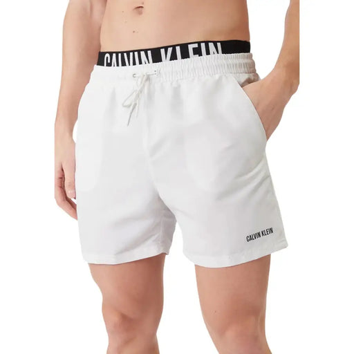 Calvin Klein Jeans men swimwear white polyester swim trunks with black elastic waistband and logo embroidery