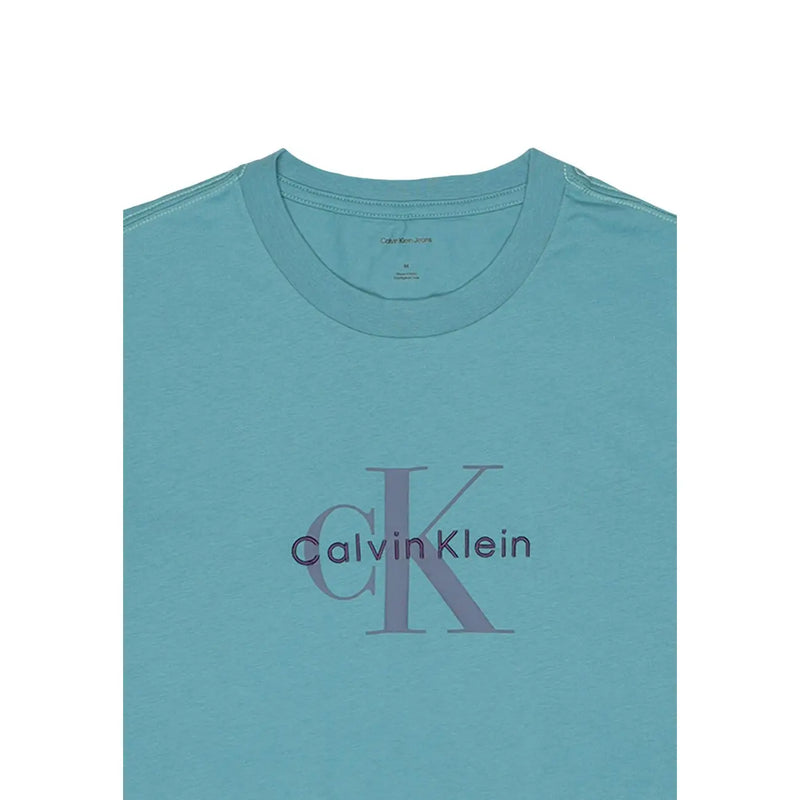 Light blue Calvin Klein Jeans men t-shirt featuring a subtle purple CK logo printed across the chest