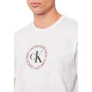 White Calvin Klein Jeans men t-shirt featuring a circular red logo with ck initials and text on the front