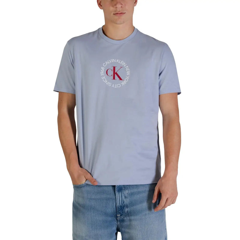 Light blue Calvin Klein Jeans men t-shirt featuring a circular red and white ck logo on the front