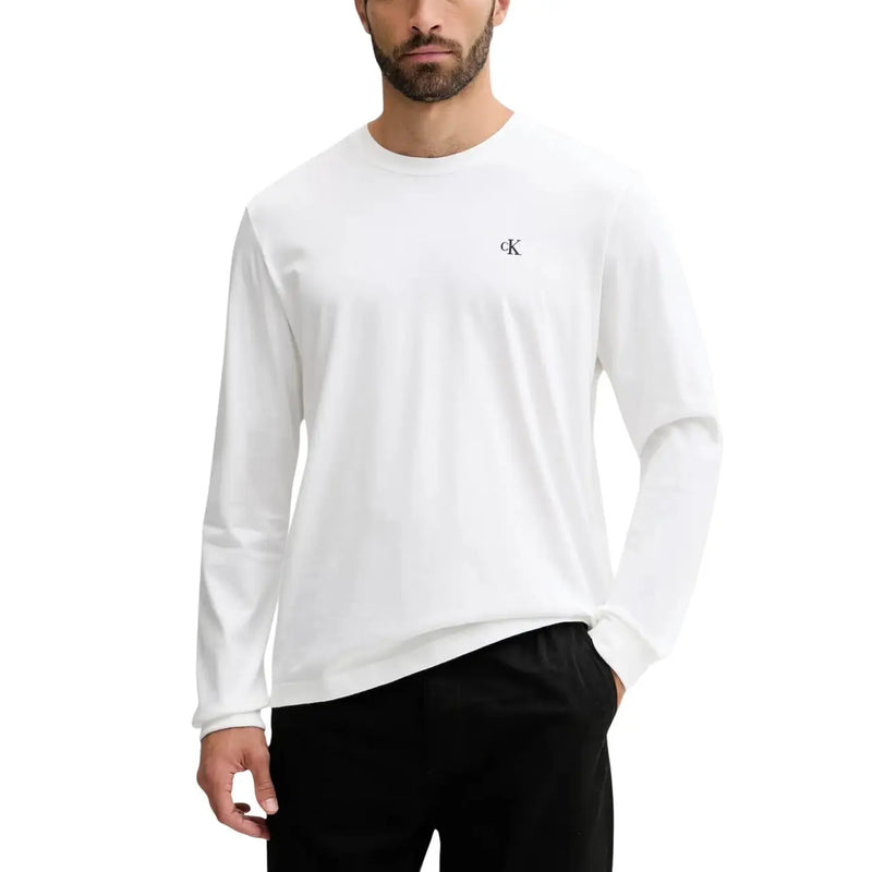 White long-sleeved crew neck cotton t-shirt with a small black ck logo on the left chest by Calvin Klein Jeans