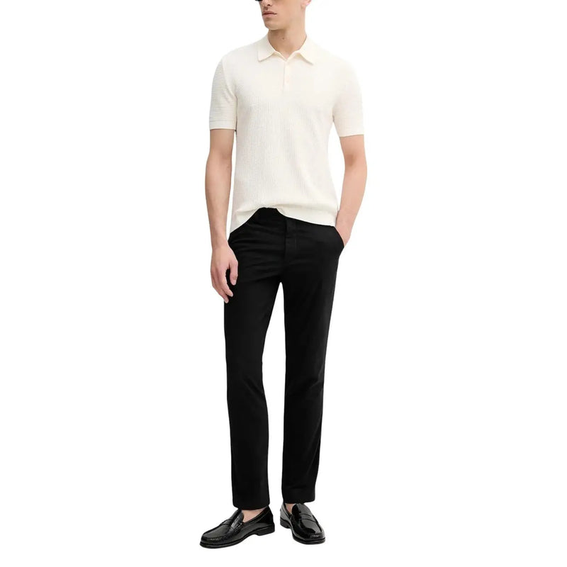 Calvin Klein Jeans men trousers paired with a cream-colored ribbed knit polo shirt with classic collar and short sleeves