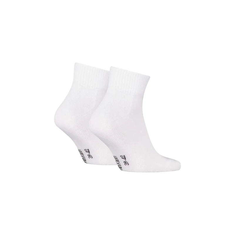 A pair of white Calvin Klein Jeans men underwear ankle socks with black text on the back heel in minimalist design