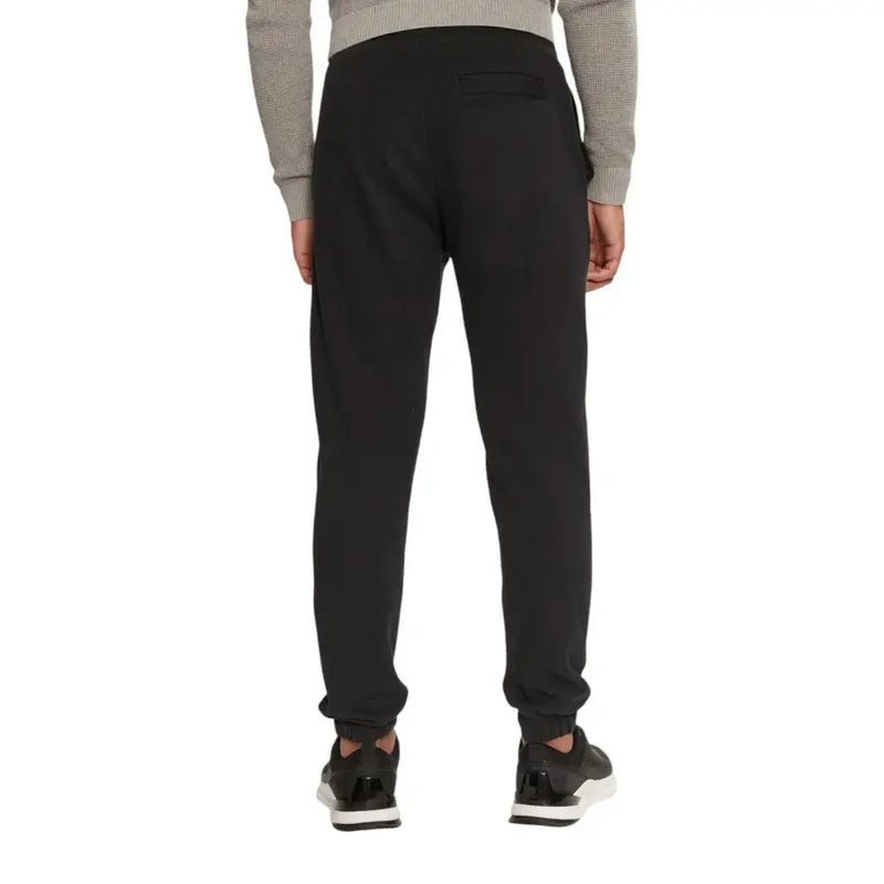 Men’s black tapered sweatpants with ribbed cuffs from Calvin Klein Jeans in organic cotton