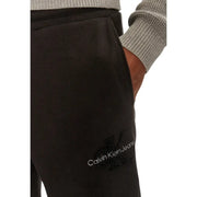 Black Calvin Klein Jeans sweatpants with white logo and embroidered CK monogram