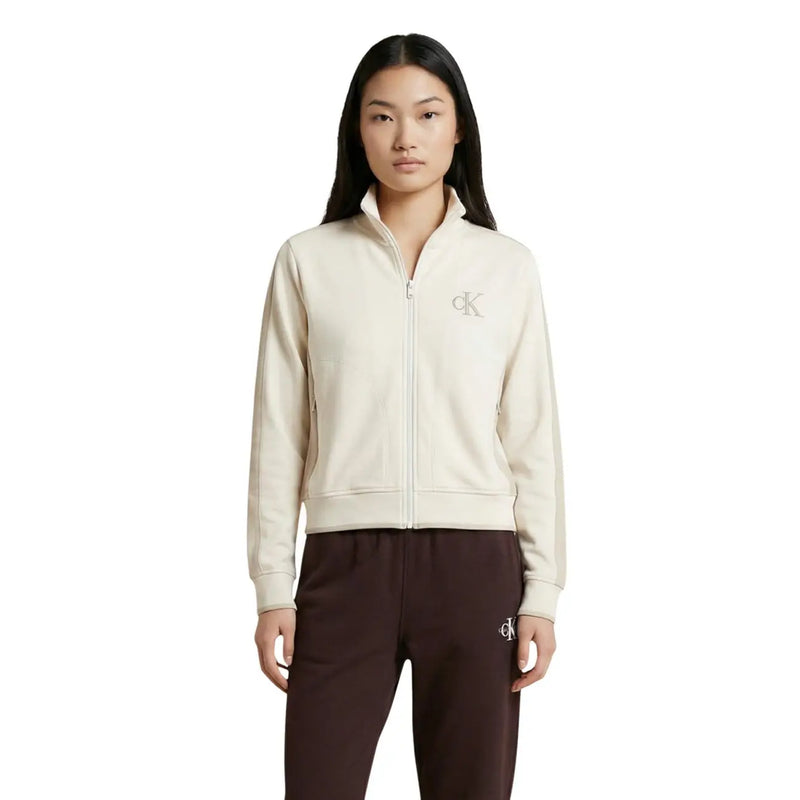 Cream-colored Calvin Klein Jeans women zip-up cotton blend track jacket with logo embroidery on chest and left leg