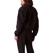 Calvin Klein Jeans women black polyester bomber jacket with ribbed cuffs and waistband shown from the back side