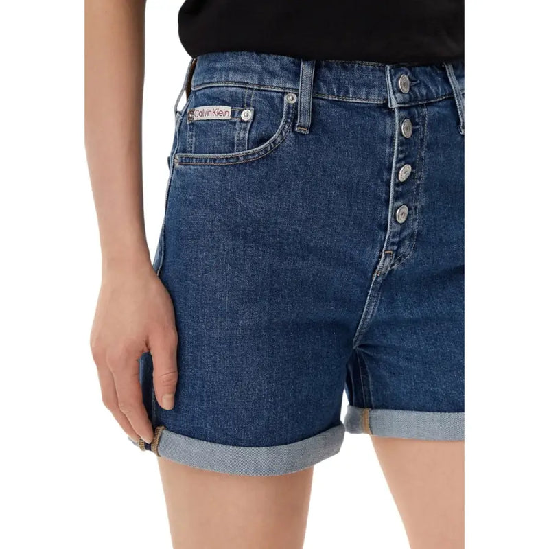 Dark blue cotton denim shorts with button-front closure rolled cuffs and Calvin Klein label on back pocket