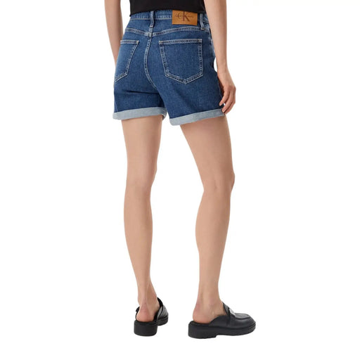 Blue cotton denim shorts with rolled cuffs and brown leather brand patch at waistband by calvin klein jeans women
