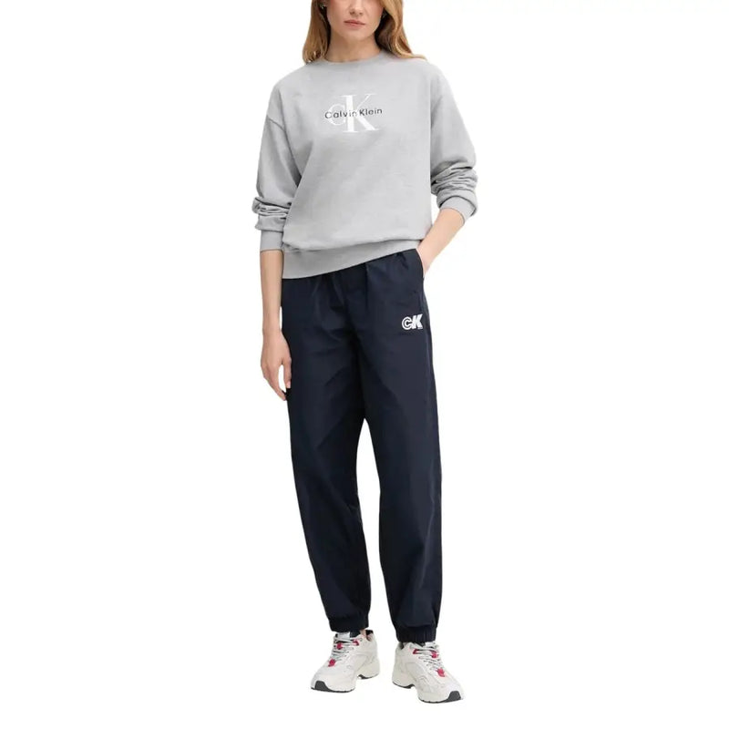 Calvin klein jeans women blue polyester trousers paired with a gray sweatshirt with white logo and navy joggers