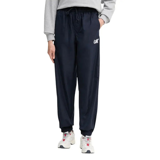 Navy blue polyester drawstring jogger pants with white logo on left thigh from Calvin Klein Jeans women collection