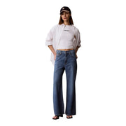 Blue denim wide-leg jeans paired with calvin klein jeans women white cotton round neck t shirt front view