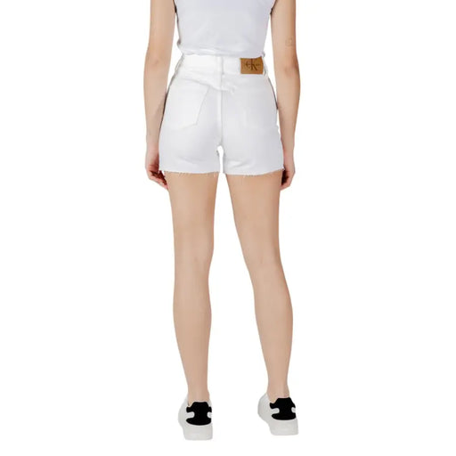 Calvin klein jeans women white high-waisted cotton denim shorts with frayed hem and brown leather brand patch back view