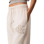 Cremefarbene weiße Baumwoll-Jogginghose von Calvin Klein für Damen mit strukturiertem, gesticktem Logo und Spitzendetails am Oberschenkel