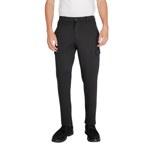 Men’s black cargo pants with dark brown shoes from Calvin Klein Winter Trousers collection