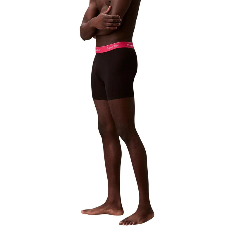 Black Calvin Klein boxer briefs with vibrant pink logo waistband designed for men’s underwear comfort and style
