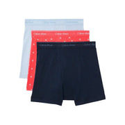 Set of three Calvin Klein men boxer briefs in light blue, red with CK logo pattern, and solid black cotton fabric