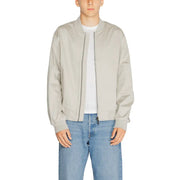 Men’s light grey bomber jacket with white t-shirt and blue jeans displayed in Calvin Klein product