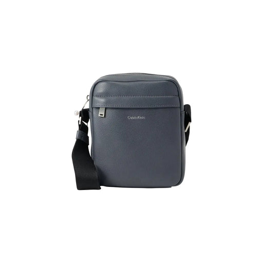 Dark gray Calvin Klein men shoulder bag with black strap, silver hardware, and black zip pockets measuring 18x23x7 cm